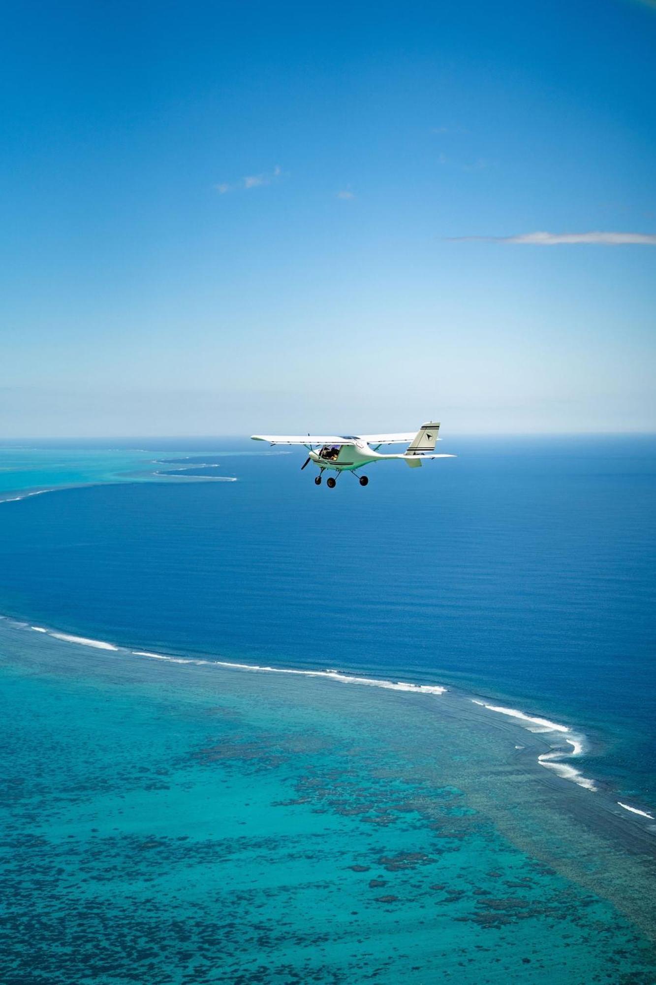 Sheraton New Caledonia Deva Spa & Golf Resort Bourail Exterior photo A Cessna 172 flying over the Great Barrier Reef